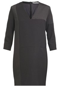 Robe noire avec un décolleté en V, des manches trois-quarts et un design bicolore. Fabriquée en tissu lisse avec une poche à l'avant au niveau de la taille.