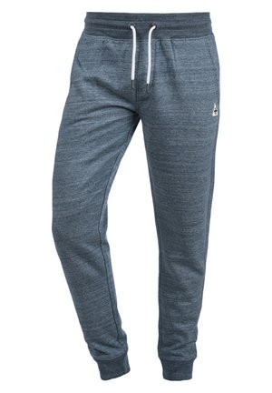 Mænds blå melerede joggingbukser med elastisk talje, hvide snore, sidelommer og tilspidsede ankelmanchetter.