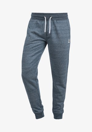 Pantalon de jogging bleu chiné pour homme avec taille élastique, cordons blancs, poches latérales et bas de jambes resserrés.