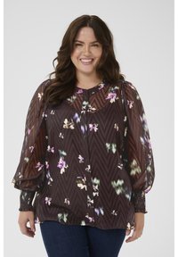 Sheer brown blouse with floral pattern, button-down front, and smocked cuffs. Features a zigzag texture and relaxed fit.