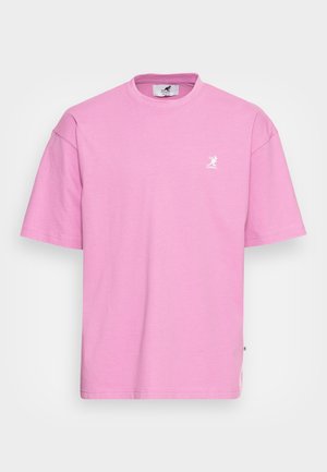 Pink short-sleeve t-shirt made from cotton. Features a crew neck and a small white logo on the left chest area. Slightly oversized fit.