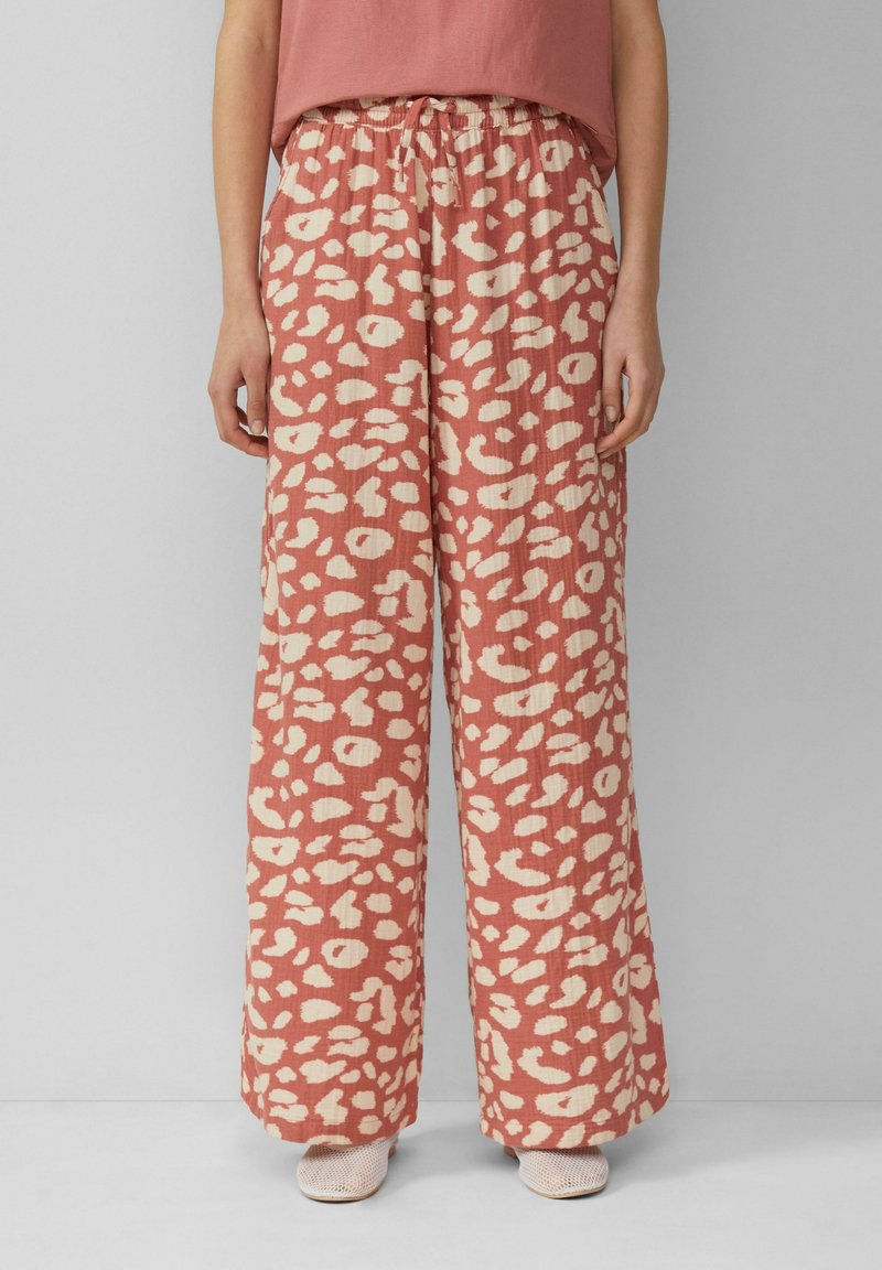 Weite Hosen in staubigem Rosé mit einem cremefarbenen Leopardenmuster; aus leichtem Stoff gefertigt, mit einem elastischen Bund und Kordelzug.