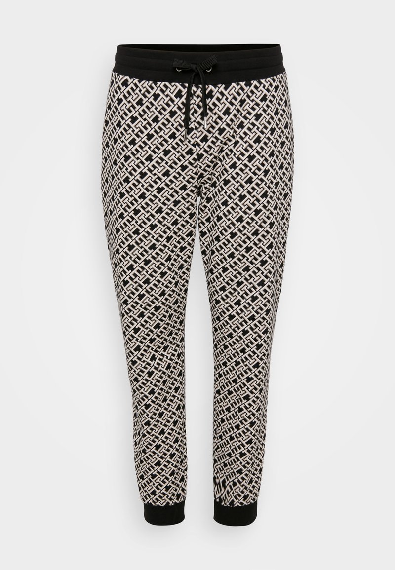 Zwarte en beige ontworpen joggers met een trekkoord in de taille en elastische manchetten, voorzien van een ingewikkeld geometrisch patroon.