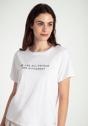 White cotton t-shirt with short sleeves and a relaxed fit. Features black text reading "WE ARE ALL UNIQUE AND DIFFERENT" on the front.