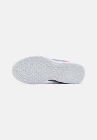 Shoe sole featuring a white rubber material with a hexagonal pattern, rounded toe shape, and colorful upper design in shades of blue and pink.