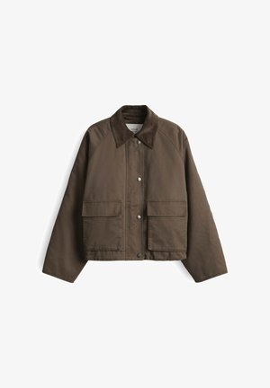 Brown canvas jacket with a button-up front, two large pockets, and a contrasting collar, featuring raglan sleeves and a textured finish.