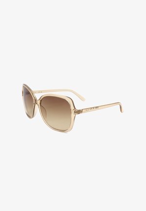 Occhiali da sole quadrati oversize beige con lenti marroni sfumate e sottili aste beige abbinate.