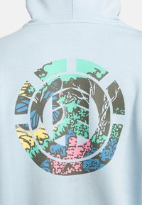 Light blue hoodie featuring a large graphic on the back with a butterfly and abstract nature design in green, pink, yellow, and blue.
