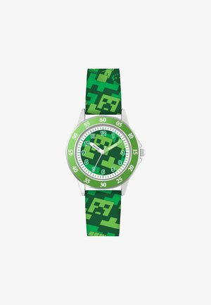 Montre verte avec un bracelet en silicone à motifs présentant des designs pixelisés. Le cadran rond comporte de grands marqueurs des heures en vert et blanc ainsi que des aiguilles.