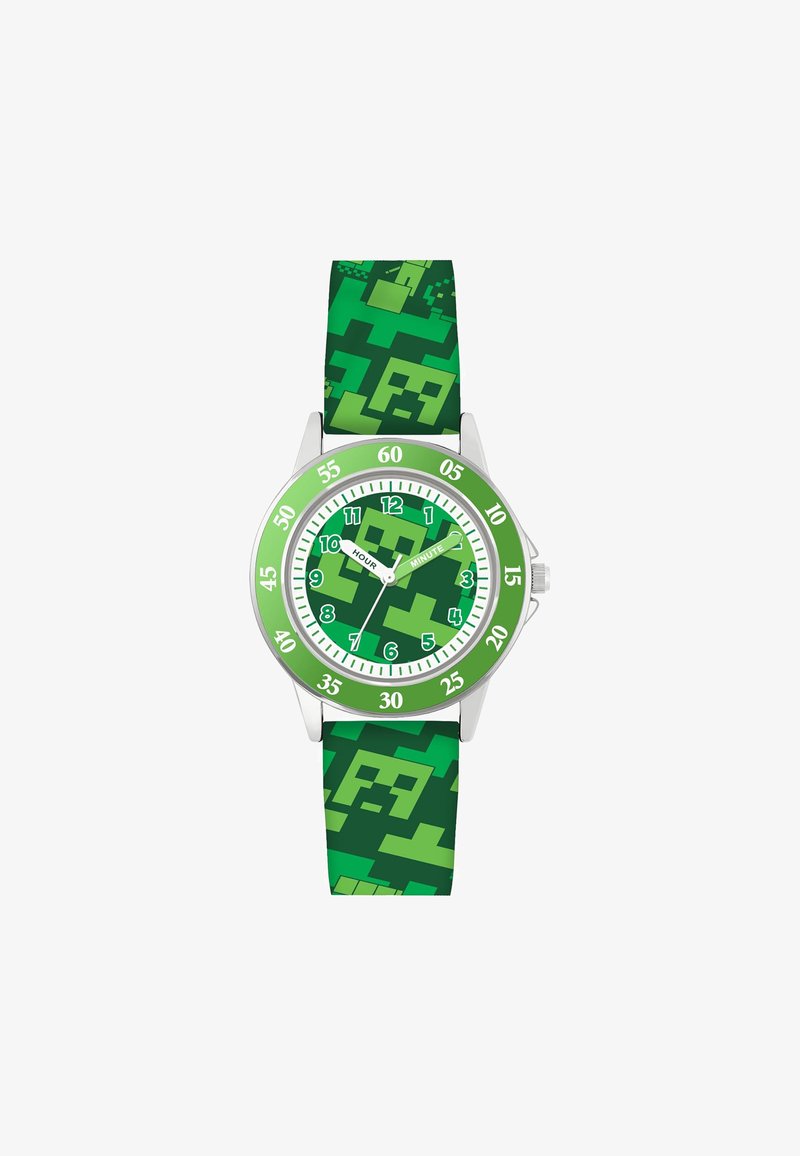 Montre verte avec un bracelet en silicone à motifs présentant des designs pixelisés. Le cadran rond comporte de grands marqueurs des heures en vert et blanc ainsi que des aiguilles.