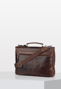 Brown leather briefcase with a rectangular shape. Features a top handle, adjustable strap, front zip pocket, and subtle texture.