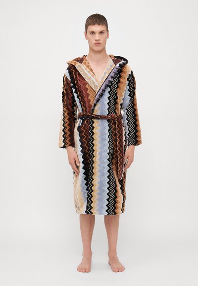 Robe de bain à capuche avec un motif en zigzag dans des tons de marron, noir, crème, bleu et violet ; fabriquée en tissu texturé ; présente une taille nouée et des manches longues.