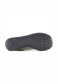 Shoe sole with a rugged black rubber design, featuring deep treads and speckled texture for traction and durability.