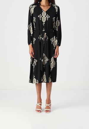 Robe noire à manches longues et décolleté en V, ornée d'un motif floral crème. Comprend une ceinture assortie et est de longueur genou.