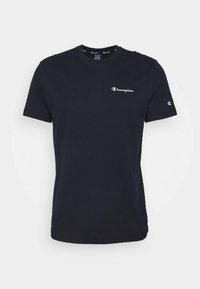 Black cotton t-shirt featuring a crew neck, short sleeves, and a white Champion logo on the chest and sleeve. Soft texture.