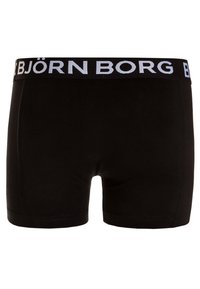 Črne bombažne bokserice z širokim črnim pasom, na katerem je v belem napisan "BJÖRN BORG". Gladka tekstura z minimalnimi detajli šivanja.
