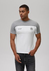 Men's short-sleeve t-shirt with grey sleeves and a white body, featuring a logo and text. Smooth cotton material, round neck design.