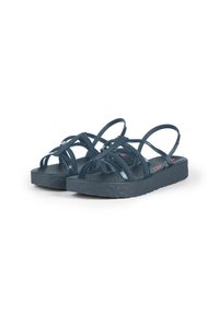 Navy blue sandals with multiple overlapping straps, made of glossy material. Textured footbed and thick, patterned soles for grip.