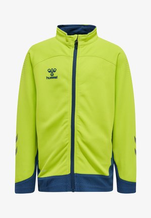 Grüne Sportjacke mit Reißverschluss vorne, marineblauen Akzenten, strukturierter Stoff und Logo auf der linken Brust. Mit Mesh-Details an den Seiten.