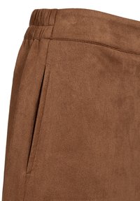 Bruna mockalädersbyxor med elastisk midja och sidofickor, med en mjuk textur och en slät finish.