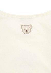 White t-shirt featuring a soft, embroidered bear face in beige and brown on the back near the neckline. Smooth fabric texture.