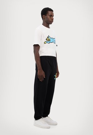 CONES & BONES  - Tracksuit bottoms - black