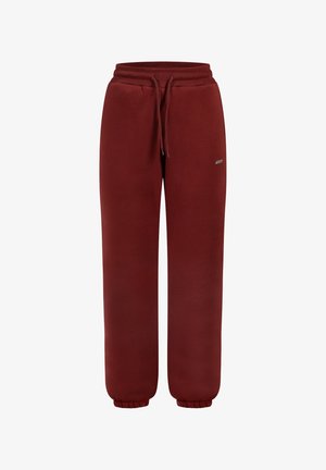 Ciemnoczerwone dresy z elastycznym paskiem w talii, sznurkiem, bocznymi kieszeniami, małym logo na lewej udzie i elastycznymi mankietami przy kostkach.