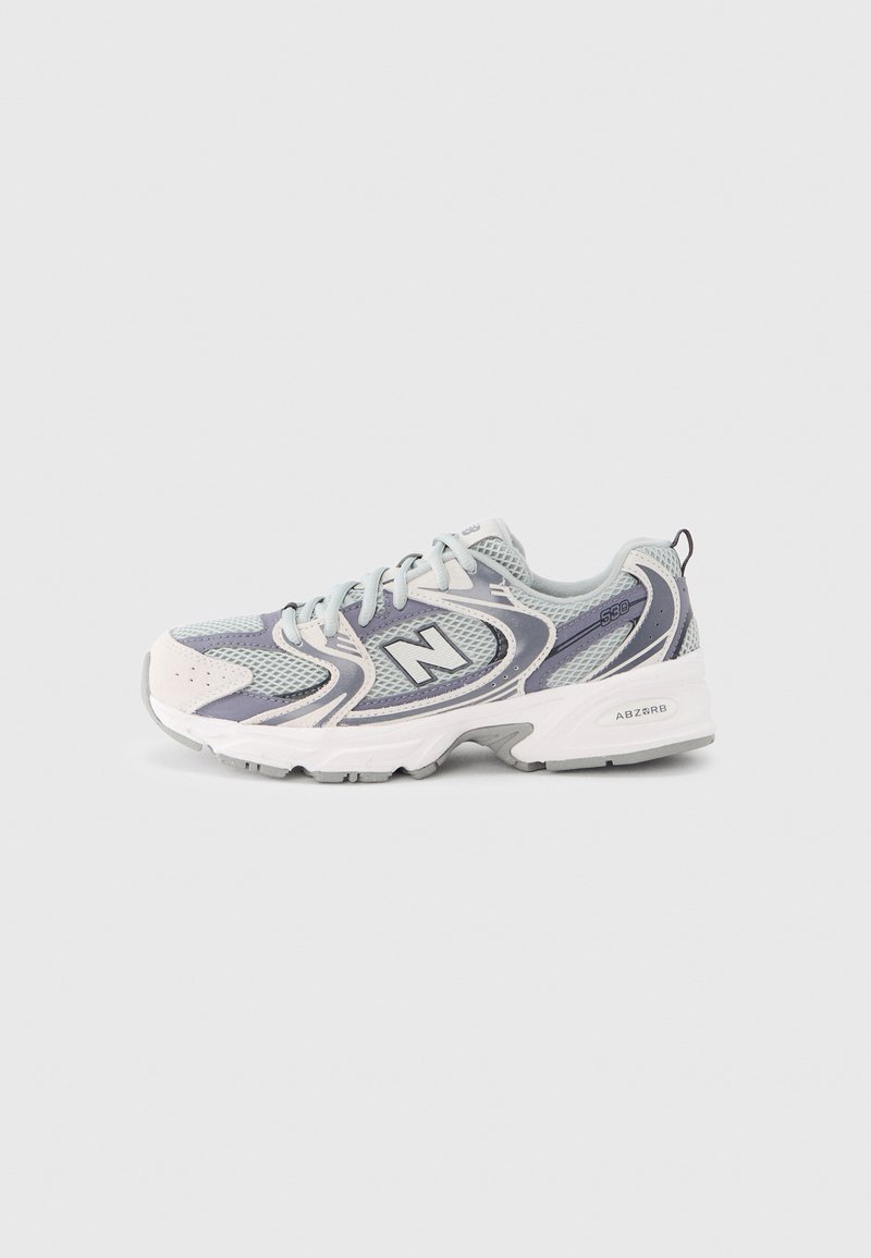 Light grey running shoes with a mesh upper, featuring navy accents, a padded collar, and a textured white outsole. Marked with a logo.