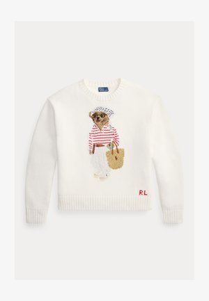 Bílý pletený svetr s výšivkou psa v slunečních brýlích, pruhovaném tričku, bílých kalhotách, držícího pletenou tašku a s iniciály "RL".