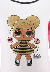 White shirt with pink sleeves features a glittery character wearing a black and gold striped dress, black shoes, and oversized round hair.