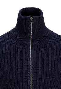 Navy blue knitted zip-up sweater with a high collar, featuring a metal zipper and ribbed texture throughout.
