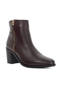 Brown leather ankle boot with a pointed toe, side zipper, and a block heel. Smooth texture, featuring a shiny finish and gold hardware.