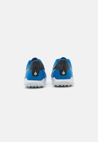 Blue and black athletic shoes with a textured upper, contrasting accents, and a white sole featuring a grip pattern, shown from the back.