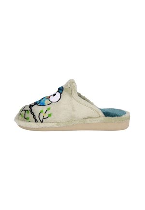 Zapatilla suave en color beige, tipo mocasín, con diseño de búho azul y hoja verde, interior de felpa en color teal y suela en color marrón, vista lateral.