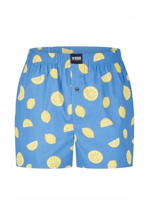 Blauwe boxers met een citroenpatroon, met halve schijfjes en hele citroenen. Elastische tailleband, knoopsluiting en een lichte stof.