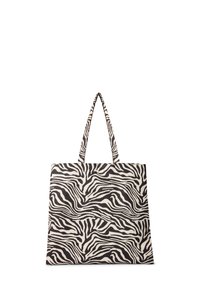 Borsa tote in canvas con design a strisce di zebra in bianco e nero, dotata di due manici lunghi e una forma rettangolare strutturata.