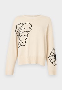 Krémový pletený svetr s černými vyšívanými květinovými vzory na přední straně a rukávu. Má kulatý výstřih a vroubkovaný lem.