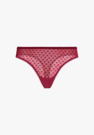 Tanga vermelha transparente com um padrão de bolinhas e um acabamento de renda ondulada na cintura, com um forro suave na parte da frente.