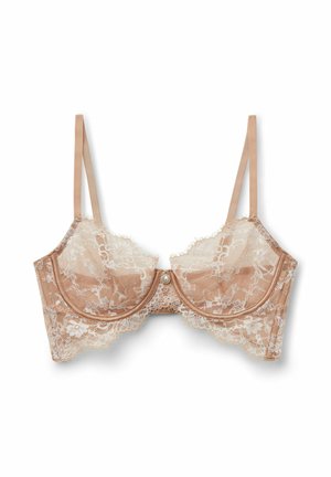 Béžová krajková podprsenka s průhlednými květinovými krajkovými košíčky, s kosticemi, nastavitelnými tenkými ramínky a malým dekorativním perlovým detailem uprostřed.