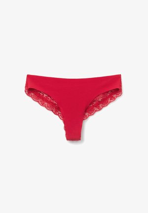 Červené tanga vyrobené z hladké látky, s krajkovým lemováním podél okrajů, které mají zvlněný design pro přidaný detail.