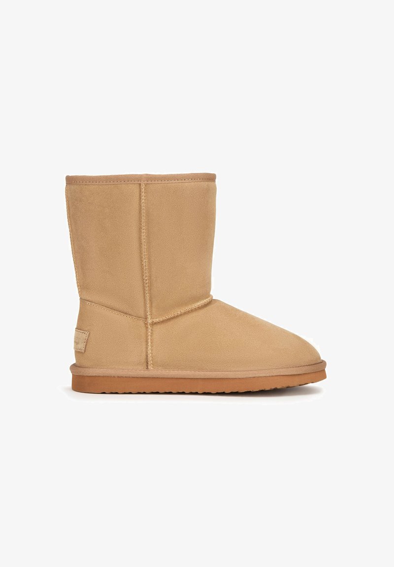 Tan suede mid-calf boot with visible stitching, flat rubber sole, and rounded toe, designed for casual wear.