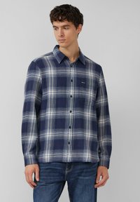 Marineblauw geruit flanellen overhemd met witte en lichtblauwe ruitpatronen, knoopsluiting aan de voorkant, kraag en een klein borstzakje. Gemaakt van katoen.