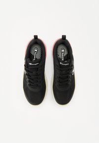 Zwarte sportschoenen met een bovenkant van mesh, textuurdetails, een contrasterende neonroze hak en een limoengroene zool. Vetersluiting, logo aan de zijkant.