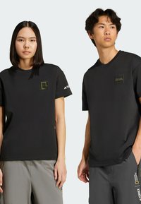 Black short-sleeve t-shirts with a fitted design. Features a small square logo on the chest and matching accents on the sleeves.