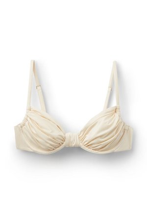 Cremefarvet satin-bh med rynkede skåle og justerbare skulderstropper på hvid baggrund.