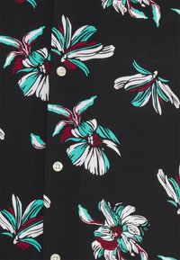 Black fabric shirt featuring a floral pattern in turquoise, white, and burgundy. Includes white buttons along the front.