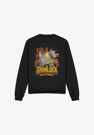Black crewneck sweatshirt featuring a graphic print of a dinosaur character with yellow accents and comic-style text in orange and white.