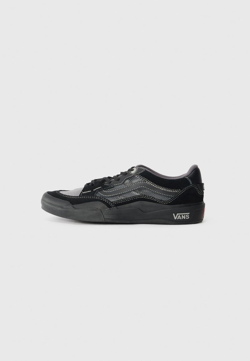 Black Vans sneakers with a suede and canvas upper, featuring contrasting white stitching, a low profile, and a textured rubber sole.