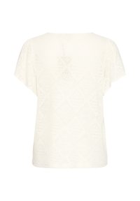 Īsroku ikru krāsas adīts tops ar dimanta rakstu un plašu izgriezumu, redzams no aizmugures uz baltas fona.