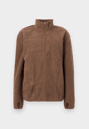 Brun fleecetröja med hög krage, hel dragkedja framtill och två sidofickor. Ribbstickade muddar med tumhål. Texturerad, mjuk yta.